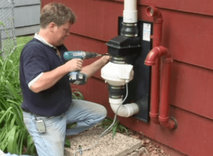 person working on a radon mitigation system