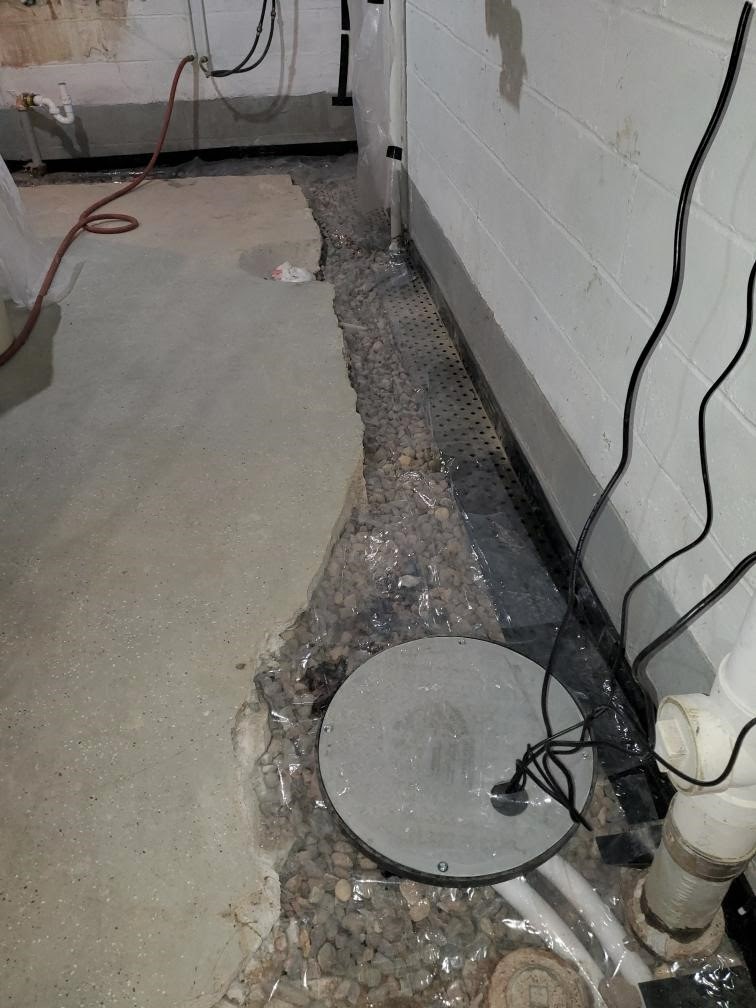New Sump Pump with New Drain Tile and Sump Pump Basin during a Basement Waterproofing Installation 