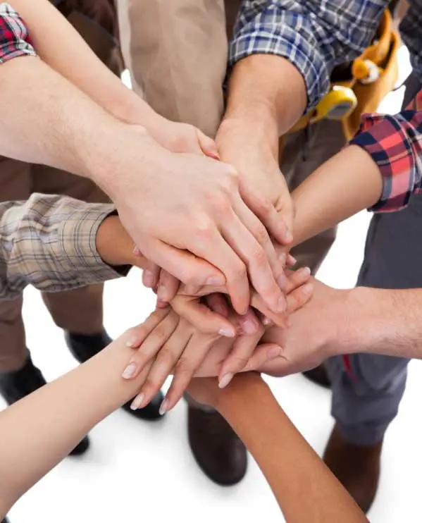 Closeup of hands stacked on top of each other.