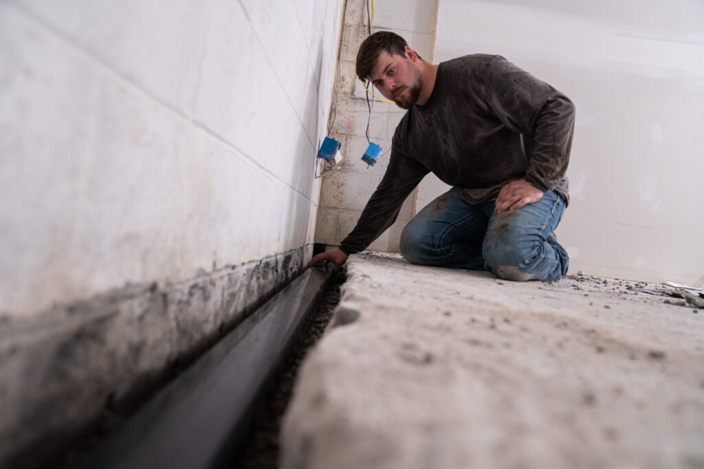standard water employee completing basement waterproofing project